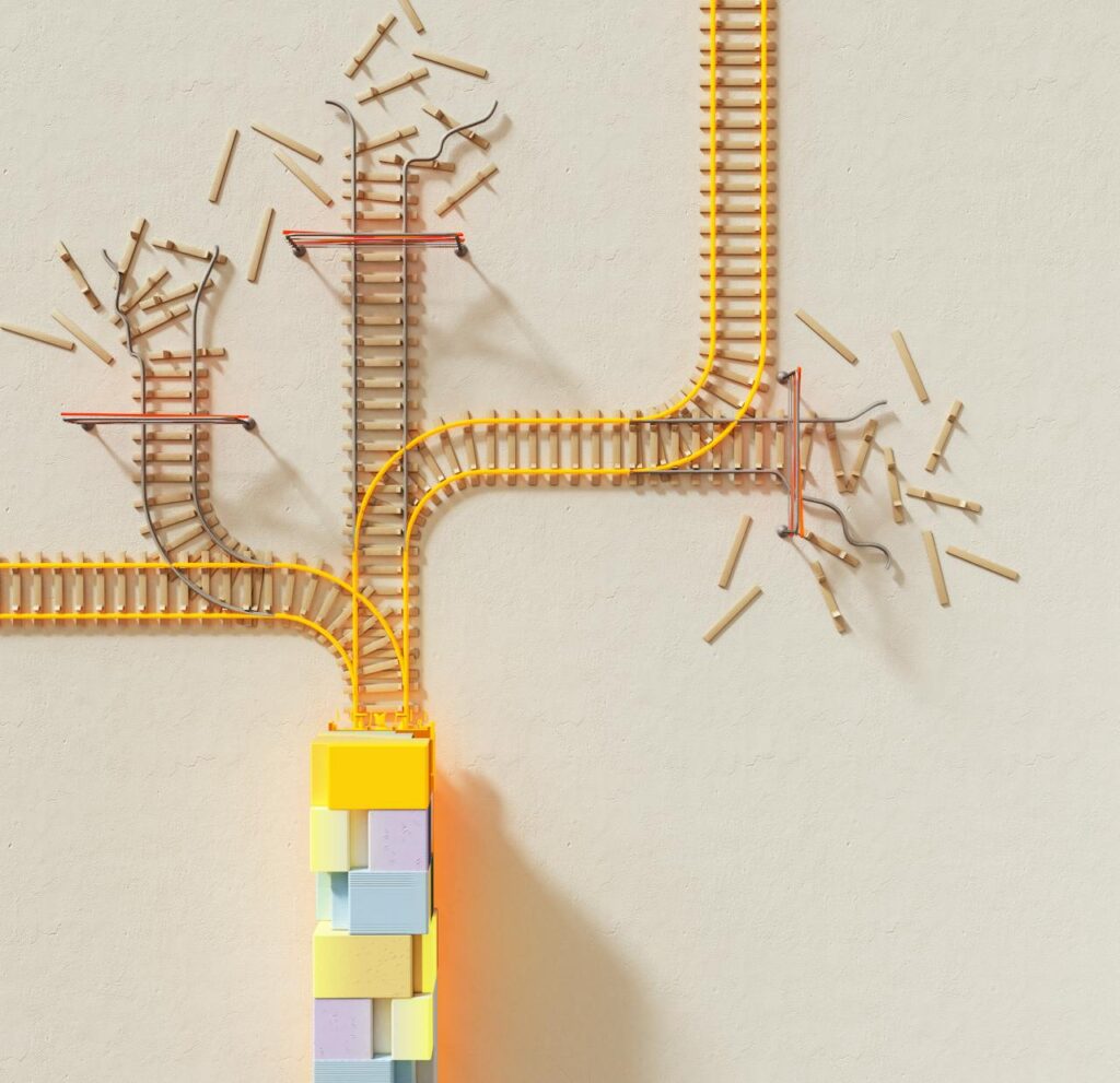pexels photo 17485633 Creative illustration of train tracks on wooden blocks, depicting decision making concepts.
