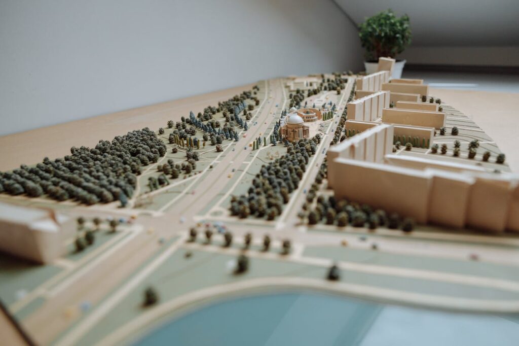 Client Stories Close-up of an architectural miniature model depicting an urban layout with buildings, roads, and greenery.
