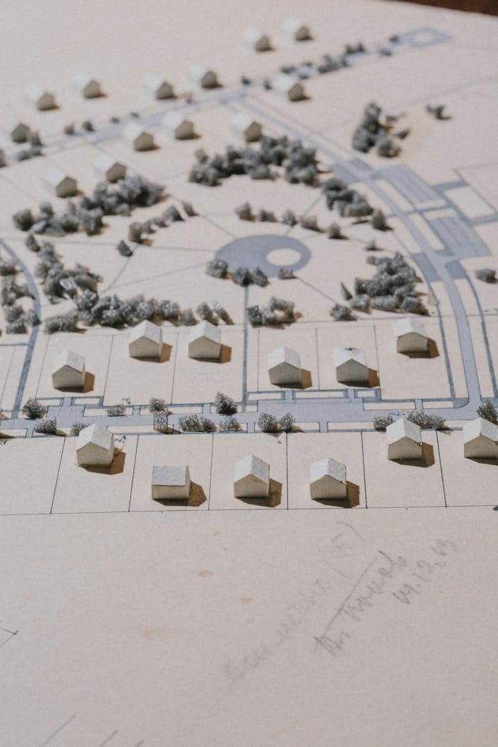 Detailed cardboard architectural model depicting houses, roads, and greenery.